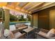 This covered patio features comfortable outdoor seating and a view of the pool at 7813 N 17Th Dr, Phoenix, AZ 85021