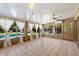 Bright sunroom with tile flooring, ceiling fan, and large windows offering pool views and lots of natural light at 7813 N 17Th Dr, Phoenix, AZ 85021