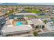 Aerial view of community center showcasing the pool, pickleball and tennis courts, and meticulous landscaping at 8037 E Navarro Ave, Mesa, AZ 85209