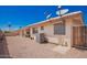 Backyard features low-maintenance desert landscaping, covered patio, Satellite dish and external air conditioning unit at 8037 E Navarro Ave, Mesa, AZ 85209