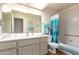 Bright bathroom with large mirror, shower, and bath with white tile and neutral walls at 8037 E Navarro Ave, Mesa, AZ 85209