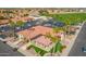 Aerial view of the clubhouse featuring palm trees and ample parking, perfect for a relaxing day on the golf course at 8037 E Navarro Ave, Mesa, AZ 85209