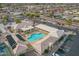 Aerial view of a community pool, clubhouse and parking lot surrounded by single-Gathering homes in a well-maintained neighborhood at 8037 E Navarro Ave, Mesa, AZ 85209