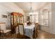 Dining room featuring a classic hutch, elegant table setting, and a decorative chandelier at 8037 E Navarro Ave, Mesa, AZ 85209