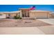 Inviting front yard featuring desert landscaping, charming curb appeal, and an American flag at 8037 E Navarro Ave, Mesa, AZ 85209