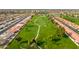 Scenic aerial view of the golf course, featuring lush green fairways, palm trees, and winding paths amidst a residential community at 8037 E Navarro Ave, Mesa, AZ 85209