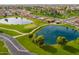 Aerial view of a beautiful golf course and lake surrounded by houses in a quiet neighborhood at 8037 E Navarro Ave, Mesa, AZ 85209
