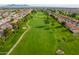 Panoramic aerial shot of a pristine golf course with tree-lined fairways in a residential area at 8037 E Navarro Ave, Mesa, AZ 85209