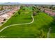 Expansive aerial view of a meticulously maintained golf course with mature trees in a residential community at 8037 E Navarro Ave, Mesa, AZ 85209