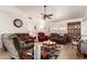 Comfortable living room showcasing neutral tile, ceiling fan, and inviting furniture arrangement at 8037 E Navarro Ave, Mesa, AZ 85209