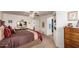 Spacious main bedroom featuring wood furnishings and a view into the ensuite bathroom and walk-in closet at 8037 E Navarro Ave, Mesa, AZ 85209