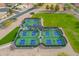 Aerial view showcases pickleball courts in a well-maintained neighborhood with mature landscaping at 8037 E Navarro Ave, Mesa, AZ 85209
