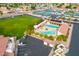 Aerial view of a pool and recreation area with mature trees and lounge seating at 8037 E Navarro Ave, Mesa, AZ 85209