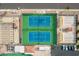 Overhead shot of two tennis courts featuring blue playing surfaces, green borders, shade structures and spectators at 8037 E Navarro Ave, Mesa, AZ 85209