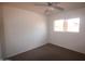 Cozy bedroom features neutral carpet, ceiling fan, and natural light from the window at 8310 N 49Th Ave, Glendale, AZ 85302