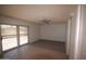 Spacious living room with tile and carpet flooring, fan, and sliding glass door at 8310 N 49Th Ave, Glendale, AZ 85302