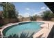 Backyard pool with brick surround and desert landscaping at 8310 N 49Th Ave, Glendale, AZ 85302