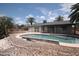 Backyard pool area with landscaping and gravel groundcover at 8310 N 49Th Ave, Glendale, AZ 85302