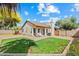 Lovely backyard with a well-maintained lawn and a cozy patio featuring a charming swing at 8335 W Pershing Ave, Peoria, AZ 85381