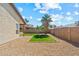 Home's backyard features a low-maintenance desert landscape with small grass patch at 8335 W Pershing Ave, Peoria, AZ 85381