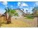 View of gravel-filled backyard with minimal landscaping and palm tree at 8335 W Pershing Ave, Peoria, AZ 85381