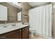 Bathroom features a vanity with sink and a shower/tub with white curtain at 8335 W Pershing Ave, Peoria, AZ 85381