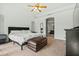 Bedroom features a ceiling fan, large bed, and entryway to the bathroom at 8335 W Pershing Ave, Peoria, AZ 85381