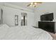 Bedroom features a ceiling fan, large bed, and dark wood dresser at 8335 W Pershing Ave, Peoria, AZ 85381