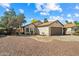Tan home with brown roof, a single car garage, and desert landscaping at 8335 W Pershing Ave, Peoria, AZ 85381