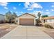 Tan house with desert landscaping and a single car garage with brown door at 8335 W Pershing Ave, Peoria, AZ 85381