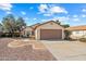 Single car garage with tan home and desert landscaping at 8335 W Pershing Ave, Peoria, AZ 85381