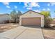 Single car garage with brown door, set in a desert landscaped front yard under a blue sky with clouds at 8335 W Pershing Ave, Peoria, AZ 85381