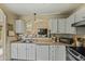 Bright kitchen with white cabinets and a sink that overlooks the living space at 8335 W Pershing Ave, Peoria, AZ 85381