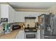 The kitchen features stainless steel appliances, and a range hood above the stove at 8335 W Pershing Ave, Peoria, AZ 85381