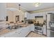 Traditional kitchen features white cabinets, stainless steel appliances, and tiled floor at 8335 W Pershing Ave, Peoria, AZ 85381