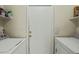 Functional laundry room features a washer, dryer, and convenient shelving at 8335 W Pershing Ave, Peoria, AZ 85381