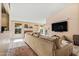 Bright living room with fireplace, large TV and access to the back patio at 8335 W Pershing Ave, Peoria, AZ 85381