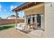Charming covered patio featuring a swing, wicker seating, and seamless indoor-outdoor flow at 8335 W Pershing Ave, Peoria, AZ 85381