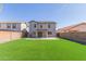 The home's rear exterior features an expansive lawn, covered patio, and neutral-toned stucco at 852 E Mountain View Rd # 18, San Tan Valley, AZ 85143