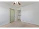 Bedroom featuring neutral carpet, a ceiling fan, a sliding door closet, and an exit at 852 E Mountain View Rd # 18, San Tan Valley, AZ 85143