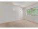 Bright bedroom with neutral carpet, white walls, and a large window with natural light at 852 E Mountain View Rd # 18, San Tan Valley, AZ 85143
