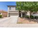 Charming two-story home featuring a well-maintained yard, mature tree, and a two-car garage at 852 E Mountain View Rd # 18, San Tan Valley, AZ 85143