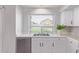 Bright kitchen featuring stainless steel dishwasher, double bowl sink, and white countertops at 852 E Mountain View Rd # 18, San Tan Valley, AZ 85143