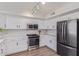 Bright kitchen features white cabinets, stainless steel appliances, light countertops, and wood floors at 852 E Mountain View Rd # 18, San Tan Valley, AZ 85143