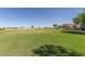 Expansive community lawn and open space with views of the surrounding homes and desert landscape at 852 E Mountain View Rd # 18, San Tan Valley, AZ 85143