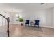 Bright living room featuring hardwood floors, stylish blue chairs, and a modern light fixture at 852 E Mountain View Rd # 18, San Tan Valley, AZ 85143