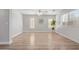 Bright living room featuring wood-look floors and multiple windows at 852 E Mountain View Rd # 18, San Tan Valley, AZ 85143
