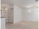 Living room with neutral carpet, a closet with sliding doors, and windows at 852 E Mountain View Rd # 18, San Tan Valley, AZ 85143