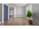 Bright, airy living room with wood-look flooring, a stylish light fixture, and a large window at 852 E Mountain View Rd # 18, San Tan Valley, AZ 85143