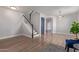 Spacious living area with stairs, wood-look floors, and entry to other rooms at 852 E Mountain View Rd # 18, San Tan Valley, AZ 85143